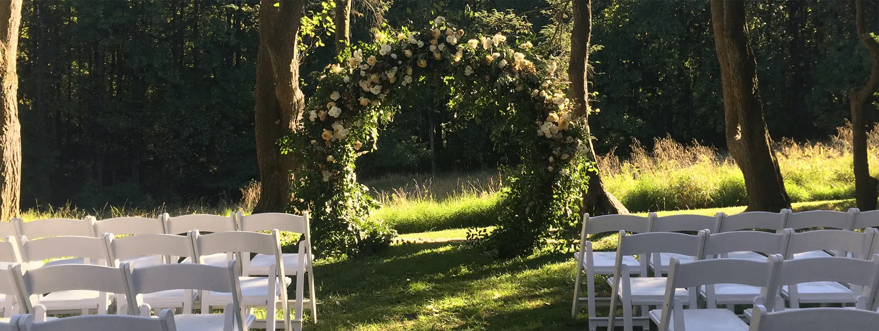 Beautiful outdoor setting for wedding with arch at Woodend Sanctuary and Mansion