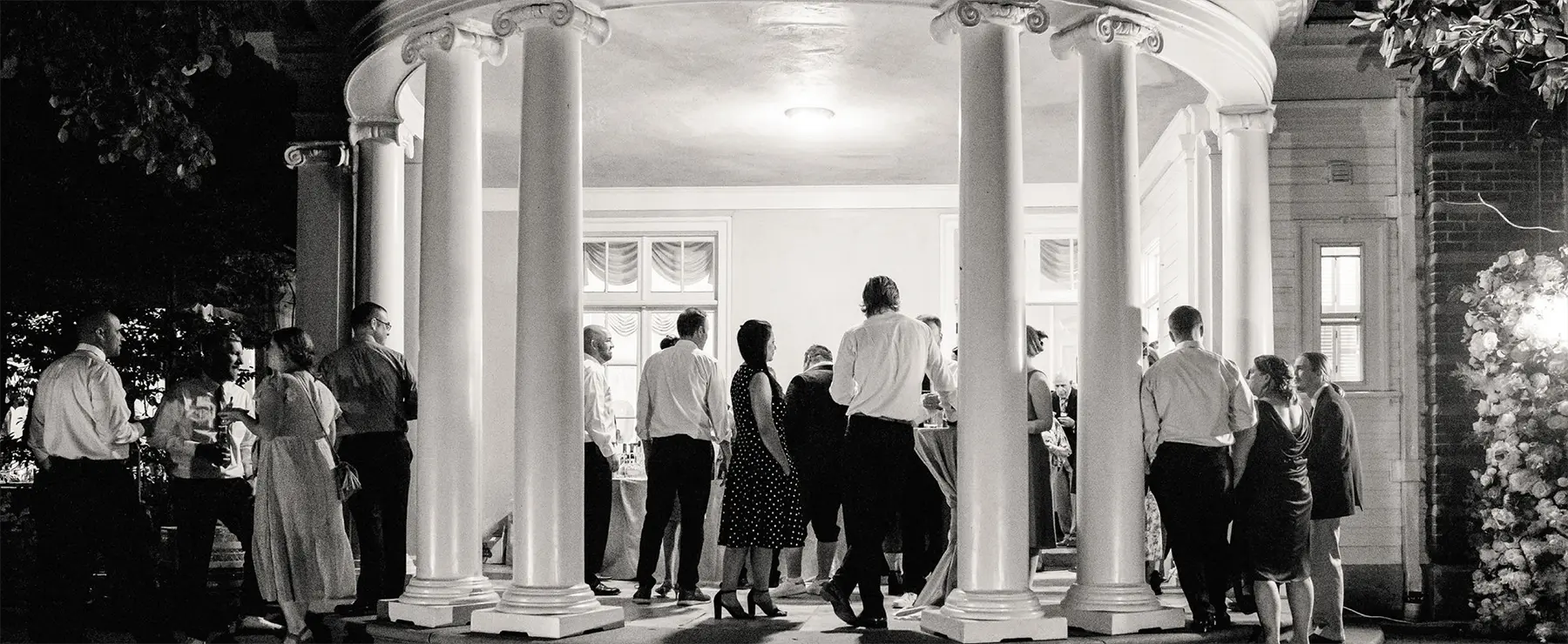 People outside the mansion socializing at a corporate event